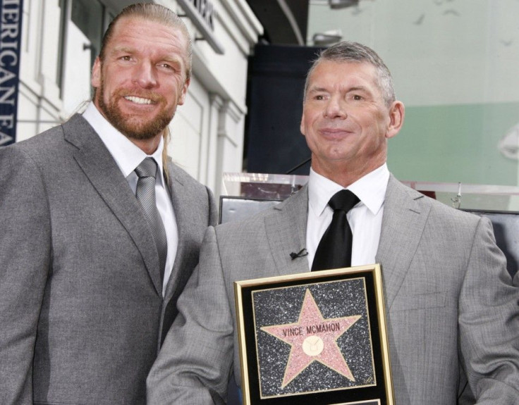 Chairman Of World Wrestling Entertainment (WWE) Inc. Vince McMahon (R) Holds A Plaque