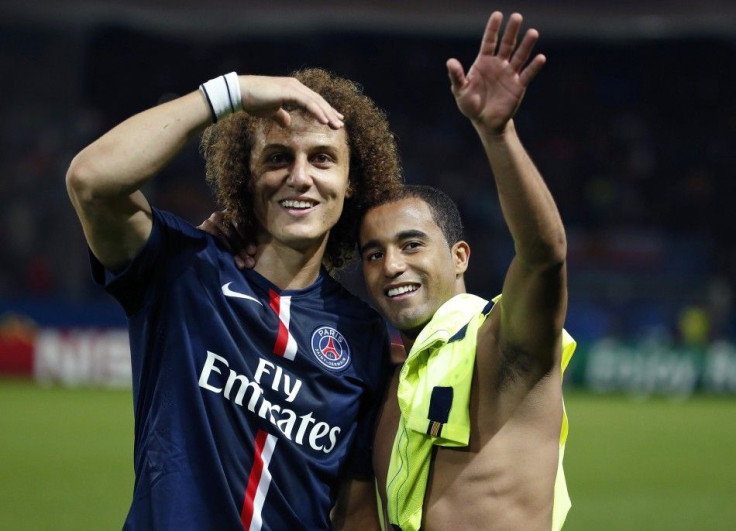 Paris St Germain's David Luiz (L) and Lucas wave to supporters after defeating Barcelona 3-2 during their Champions League Group F soccer match at the Parc des Princes Stadium in Paris, September 30, 2014.