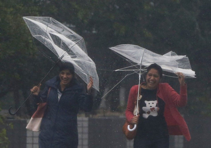 Passers-by with umbrellas struggle against strong winds and heavy rain caused by Typhoon Phanfone, in Tokyo October 6, 2014. Hundreds of flights were canceled and thousands of people advised to evacuate as a powerful typhoon lashed Japan on Monday with he
