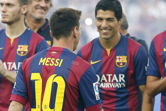 FC Barcelona's Luis Suarez smiles to teammate Lionel Messi (10) during their team presentation at Nou Camp stadium in Barcelona , August 18, 2014. FC Barcelona will play against Mexican club Leon FC for the Joan Gamper Trophy.