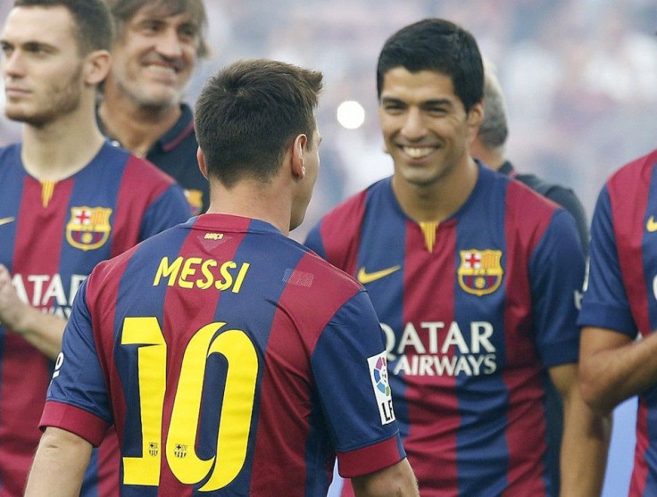 FC Barcelona's Luis Suarez smiles to teammate Lionel Messi (10) during their team presentation at Nou Camp stadium in Barcelona , August 18, 2014. FC Barcelona will play against Mexican club Leon FC for the Joan Gamper Trophy.