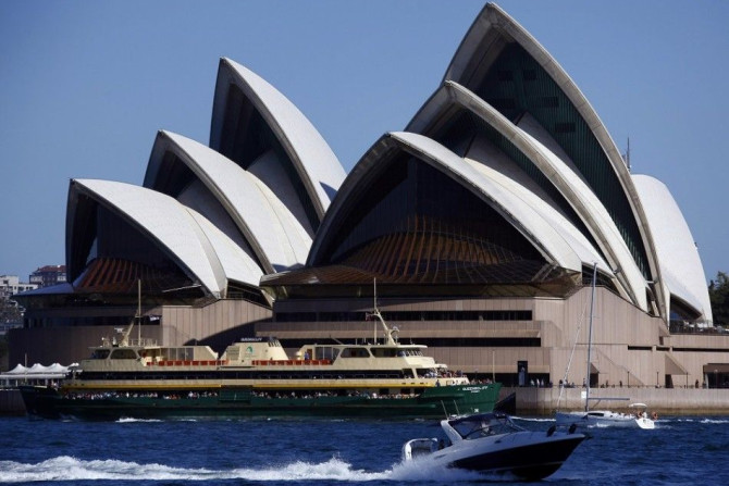 A ferry and recreational boats pass in front of the Sydney Opera House September 28, 2014. Local media reported that the Sydney Opera House Trust has been awarded an AUD$225,000 ($200,000) grant by the U.S. philanthropic organisation, the Getty Foundation
