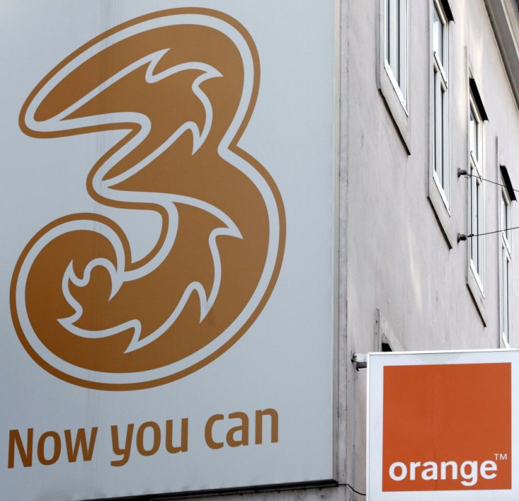 The logos of "Orange" and "3" are pictured outside a telecommunications store
