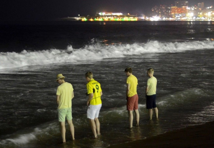 Tourists urinate into the sea off Copacabana beach, as soccer fans from many countries gathered during the 2014 World Cup, in Rio de Janeiro June 17, 2014. In a project called ?On The Sidelines? Reuters photographers share pictures showing their own quirk