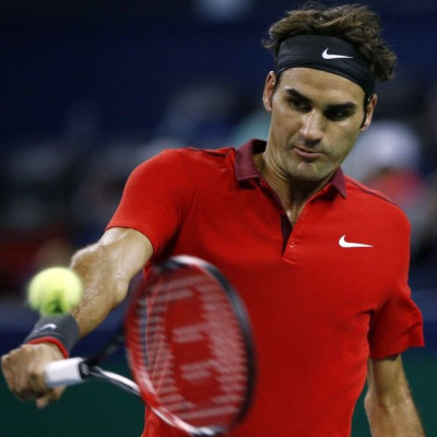 Roger Federer of Switzerland returns a shot during his men's singles tennis match against Roberto Bautista Agut of Spain at the Shanghai Masters tennis tournament in Shanghai October 9, 2014. REUTERS/Aly Song