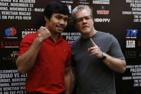 Manny Pacquiao (L) from the Philippines and his trainer Freddie Roach pose during an interview at Venetian Macao in Macau August 25, 2014. Pacquiao will fight for the WBO welterweight title against Chris Algieri from the United States at the Venetian&#039