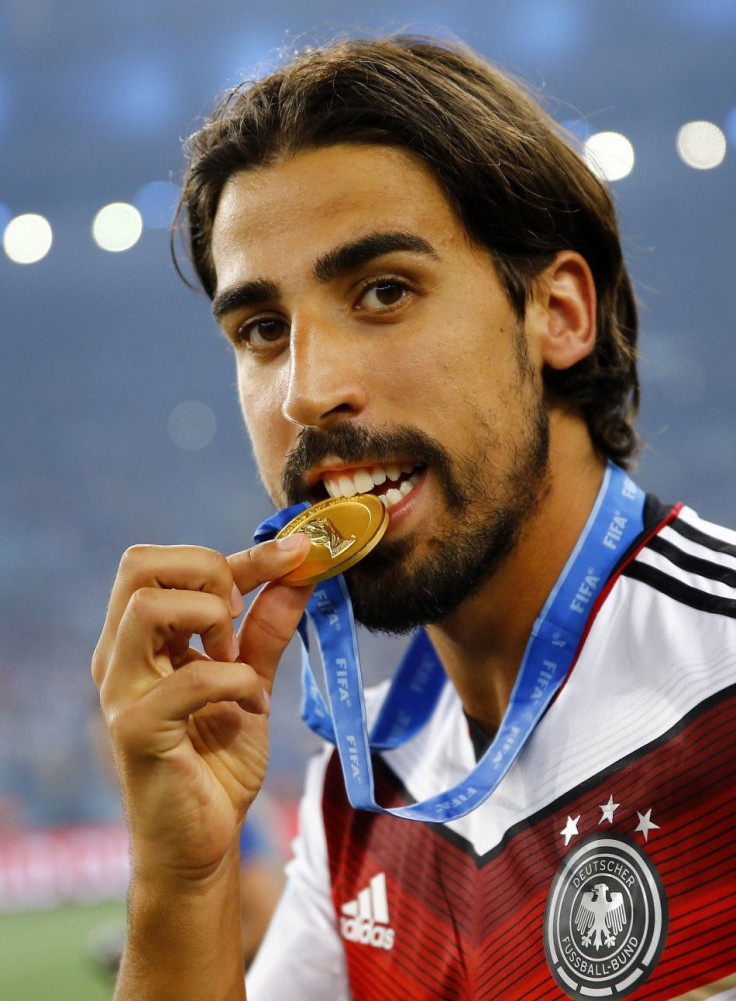 Germany's Sami Khedira bites his medal after the team won their 2014 World Cup final against Argentina at the Maracana stadium in Rio de Janeiro July 13, 2014.