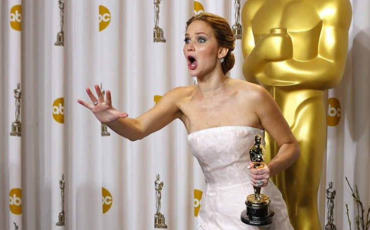 Jennifer Lawrence, best actress winner for her role in &quot;Silver Linings Playbook,&quot; reacts after photographers made a picture of her making an obscene gesture as she took the stage in the photo room with her Oscar at the 85th Academy Awards in Hol