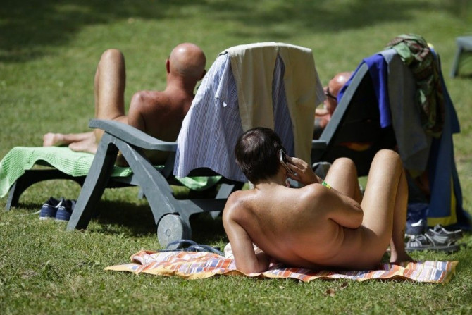 People sunbathe during the &quot;www.inudisti.it&quot; web community's annual gathering on private property at Oasis of Zello naturist resort near Bologna, central Italy, June 22, 2013. The largest Italian nudist web community has what it says are some 40