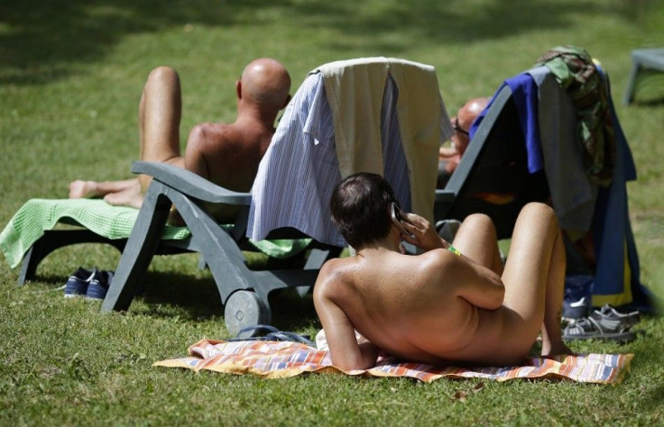 People sunbathe during the &quot;www.inudisti.it&quot; web community's annual gathering on private property at Oasis of Zello naturist resort near Bologna, central Italy, June 22, 2013. The largest Italian nudist web community has what it says are some 40