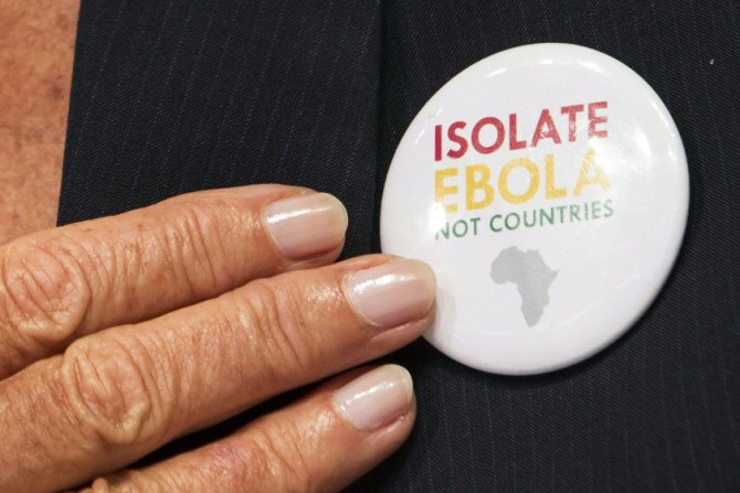 International Monetary Fund (IMF) Managing Director Christine Lagarde points to a button saying &quot;Isolate Ebola, Not Countries&quot; as she speaks during the IMFC news conference during the World Bank/IMF Annual Meeting in Washington October 11, 2014.