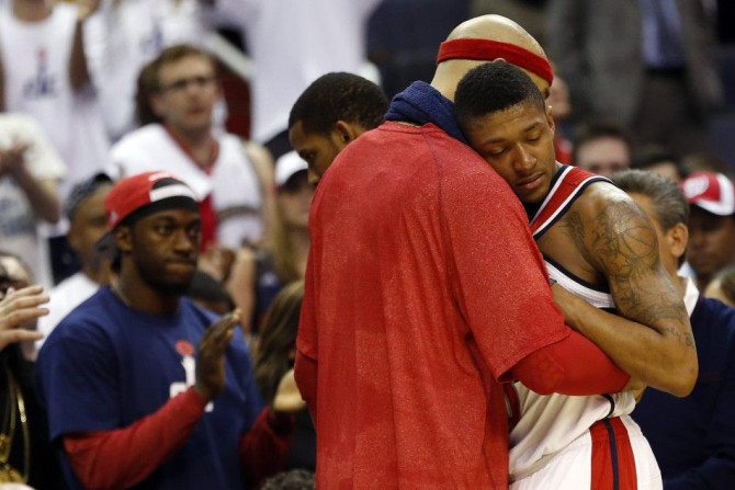 May 15, 2014; Washington, DC, USA; Washington Wizards guard Bradley Beal (3) is hugged by forward Drew Gooden (left) on the bench against the Indiana Pacers in the final minute in the fourth quarter in game six of the second round of the 2014 NBA Playoffs