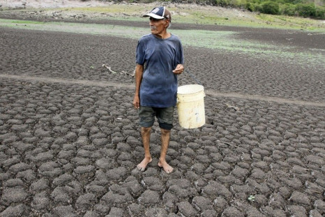 A man looks for water as he walks on ground cracked by drought in Santa Isabel August 19, 2014. According to a recent report by the Famine Early Warning Systems Network (FEWS NET), run by the US Agency for International Development (USAID), low rainfall l