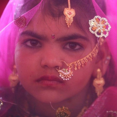 A veiled girl from the Saraniya community waits for her engagement ceremony to start at Vadia village in the western Indian state of Gujarat March 11, 2012. The Vadia village in western India hosted a mass wedding and engagement ceremony of 21 girls on Su