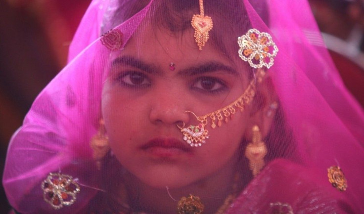 A veiled girl from the Saraniya community waits for her engagement ceremony to start at Vadia village in the western Indian state of Gujarat March 11, 2012. The Vadia village in western India hosted a mass wedding and engagement ceremony of 21 girls on Su
