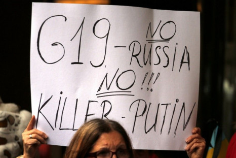 Members of the Australian Ukrainian community hold placards as they hold a rally in Sydney July 19, 2014, demanding that Russian President Vladimir Putin not be allowed to attend the G20 Leaders Summit in November. 