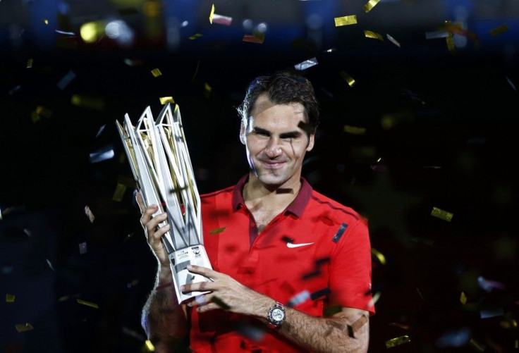 Roger Federer of Switzerland poses with the trophy after winning the men's singles final match against Gilles Simon of France at the Shanghai Masters
