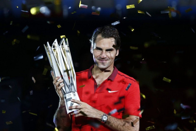 Roger Federer of Switzerland poses with the trophy after winning the men's singles final match against Gilles Simon of France at the Shanghai Masters tennis tournament in Shanghai October 12, 2014. Federer claimed one of the few titles to have previo