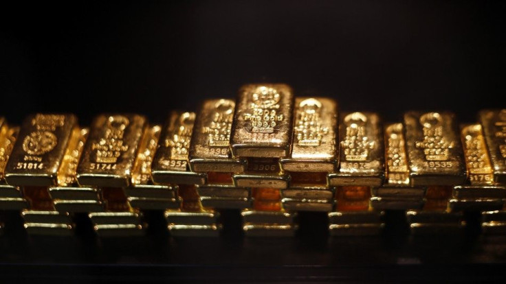 Gold bars are stacked at a safe deposit room of the ProAurum gold house in Munich March 6, 2014. Gold was flat on Thursday as diplomatic efforts to cool the Ukraine crisis depressed demand for assets seen as safe, but the metal found support above $1,330 