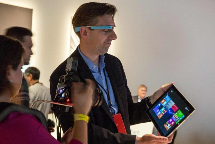 An attendee wearing Google glass uses the new Microsoft Surface Pro 3