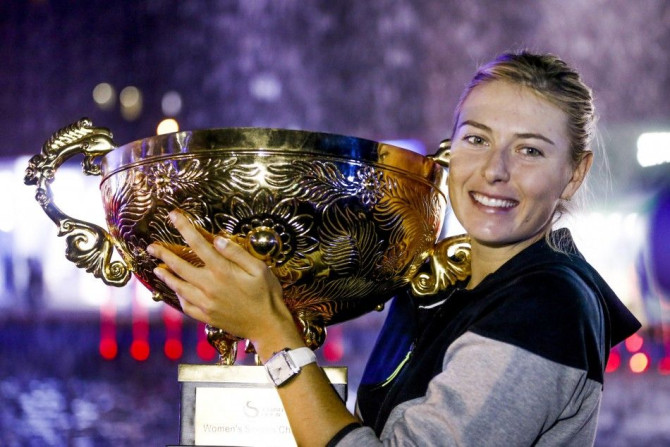 Maria Sharapova of Russia holds her trophy after she won the woman's singles final match against Petra Kvitova of the Czech Republic at the China Open Tennis Tournament, in Beijing, October 5, 2014. REUTERS/Stringer