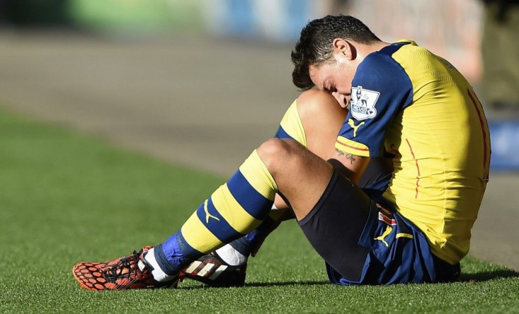 Arsenal&#039;s Mesut Ozil sits injured