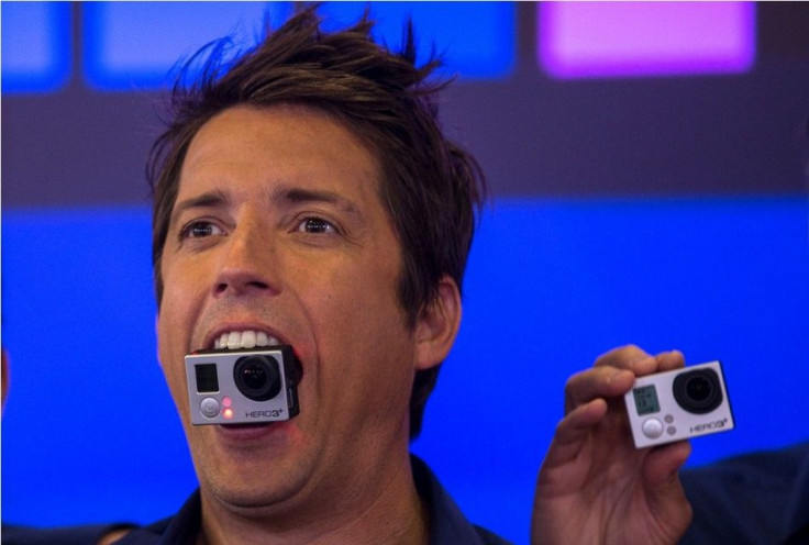 GoPro Inc&#039;s founder and CEO Nick Woodman holds a GoPro camera in his mouth
