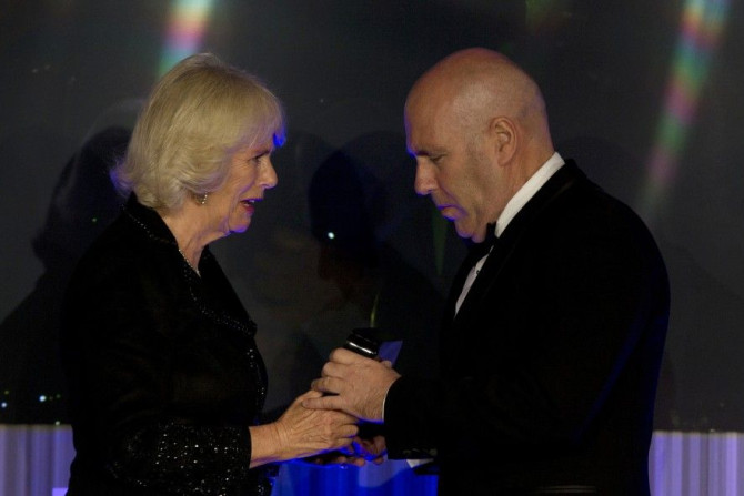 Camilla, Duchess of Cornwall, presents Australian author Richard Flanagan, who wrote &quot;The Narrow Road to the Deep North&quot;, with the trophy for the 2014 Man Booker Prize for Fiction at the Guildhall in London, October 14, 2014.