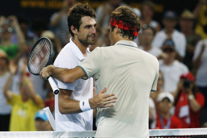 Roger Federer of Switzerland (R) meets Jeremy Chardy of France at the net after Federer won their men&#039;s singles semi-final match at the Brisbane International tennis tournament in Brisbane, January 4, 2014. REUTERS/Jason Reed