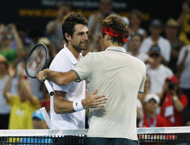 Roger Federer of Switzerland (R) meets Jeremy Chardy of France at the net after Federer won their men&#039;s singles semi-final match at the Brisbane International tennis tournament in Brisbane, January 4, 2014. REUTERS/Jason Reed