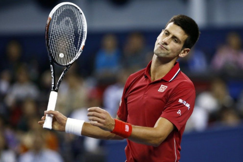 Novak Djokovic of Serbia reacts after losing a point during his men's singles semi-final match against Roger Federer of Switzerland at the Shanghai Masters tennis tournament in Shanghai October 11, 2014. REUTERS/Aly Song