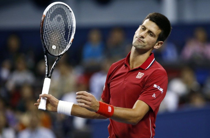 Novak Djokovic of Serbia reacts after losing a point during his men's singles semi-final match against Roger Federer of Switzerland at the Shanghai Masters tennis tournament in Shanghai October 11, 2014. REUTERS/Aly Song