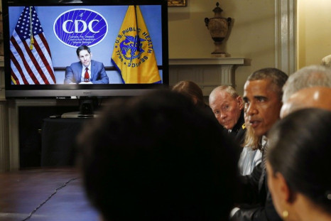 Director of the U.S. Centers for Disease Control and Prevention Tom Frieden, listens via video conference as U.S. President Barack Obama (2nd R) holds a meeting with cabinet agencies coordinating the government&#039;s Ebola response in the Cabinet Room of