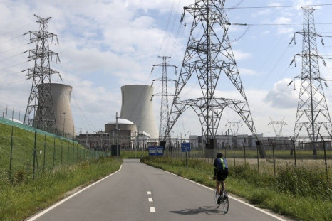 A man cycles towards Doel&#039;s nuclear plant, northern Belgium August 20, 2014. Two Belgian nuclear reactors owned by GDF-Suez unit Electrabel may remain offline until spring and may need to be halted permanently, Belgian state broadcaster VRT reported 