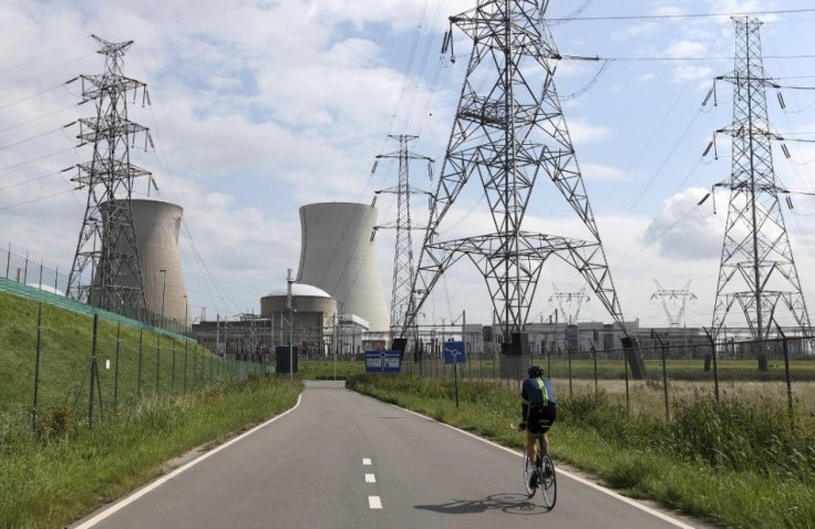 A man cycles towards Doel&#039;s nuclear plant, northern Belgium August 20, 2014. Two Belgian nuclear reactors owned by GDF-Suez unit Electrabel may remain offline until spring and may need to be halted permanently, Belgian state broadcaster VRT reported 
