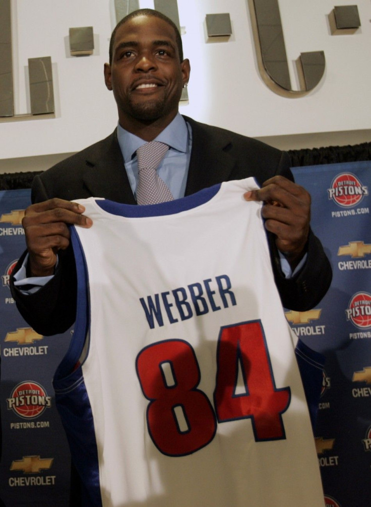 Newly signed Detroit Pistons player Chris Webber holds up his jersey during a news conference in Auburn Hills, Michigan, January 16, 2007.