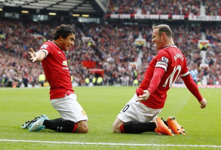 Manchester United's Wayne Rooney (R) celebrates with his teammate Rafael Da Silva after scoring a goal against West Ham United during their English Premier League soccer match at Old Trafford in Manchester, northern England September 27, 2014.