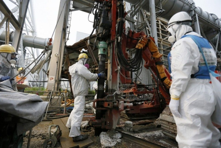 Workers conduct operations to construct an underground ice wall at Tokyo Electric Power Co.&#039;s (Tepco) tsunami-crippled Fukushima Daiichi nuclear power plant in Fukushima Prefecture July 9, 2014. The media were shown on Tuesday the site where Tepco is