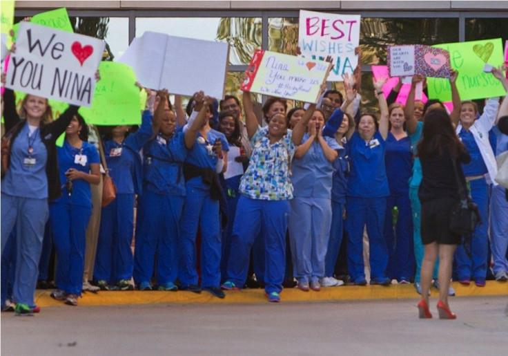Staff members of Texas Health Presbyterian Hospital gather outside the emergency room to show support for fellow nurse Nina Pham
