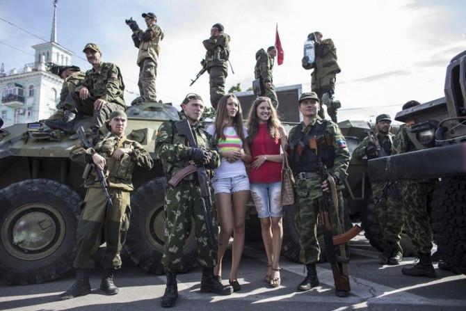 Women pose for a picture with pro-Russian rebels during a parade in Luhansk, eastern Ukraine, September 14, 2014. Ukraine's Defence Minister said on Sunday that NATO countries were delivering weapons to his country to equip it to fight pro-Russian separat