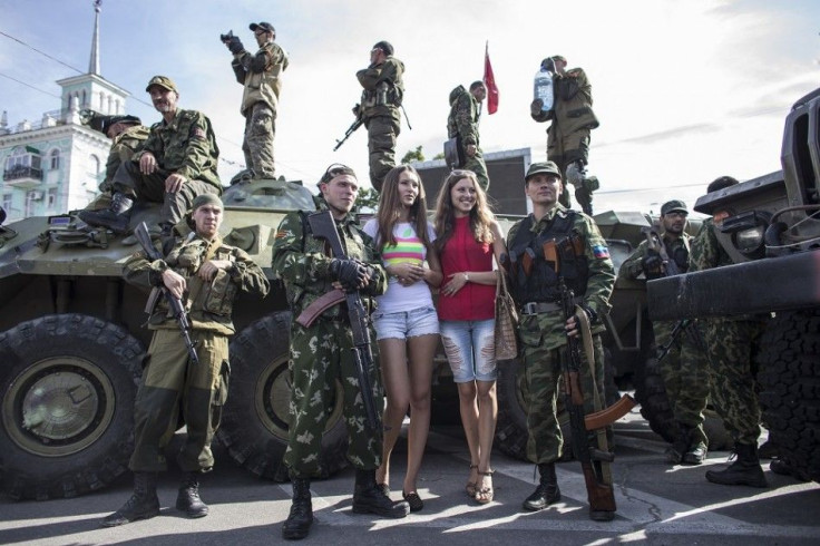 Women pose for a picture with pro-Russian rebels during a parade in Luhansk, eastern Ukraine, September 14, 2014. Ukraine's Defence Minister said on Sunday that NATO countries were delivering weapons to his country to equip it to fight pro-Russian separat