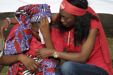 Isaac Rebecca, one of the girls that escaped from the Boko Haram camp is comforted during a protest march, in continuation of the Global Week of Action to commemorate six months since the abduction of the 219 Chibok school girls, organized by the Abuja &q
