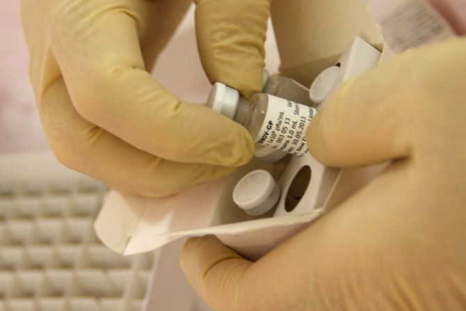 Scientists at the National Microbiology Lab in Winnipeg, Manitoba, prepare an experimental Ebola vaccine for shipment to the World Health Organization (WHO) in Geneva in this undated handout picture released October 18, 2014. 