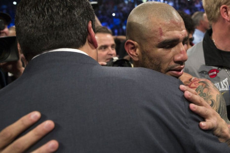 Miguel Cotto embraces a friend after winning his WBC middleweight title by defeating Sergio Martinez at Madison Square Garden in New York June 7, 2014. Cotto defeated Martinez in the 9th round