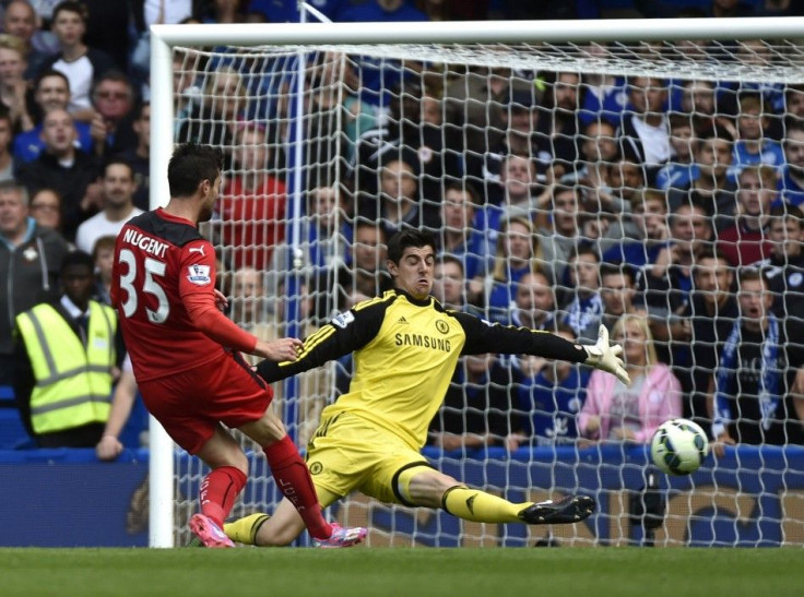 Chelsea's Thibaut Courtois (R) saves a shot from Leicester City's David Nugent during their English Premier League soccer match at Stamford Bridge in London, August 23, 2014.