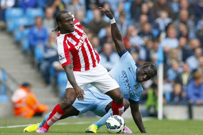 Manchester City's Bacary Sagna (R) challenges Stoke City's Victor Moses during their English Premier League soccer match at the Etihad stadium in Manchester, northern England August 30, 2014.
