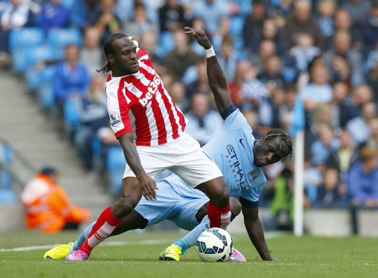 Manchester City's Bacary Sagna (R) challenges Stoke City's Victor Moses during their English Premier League soccer match at the Etihad stadium in Manchester, northern England August 30, 2014.