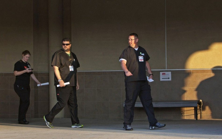 Registered nurses from the University of Texas Medical Branch are on hand to greet passengers and answer questions as the Carnival Magic cruise ship docks in Galveston, Texas October 19, 2014.