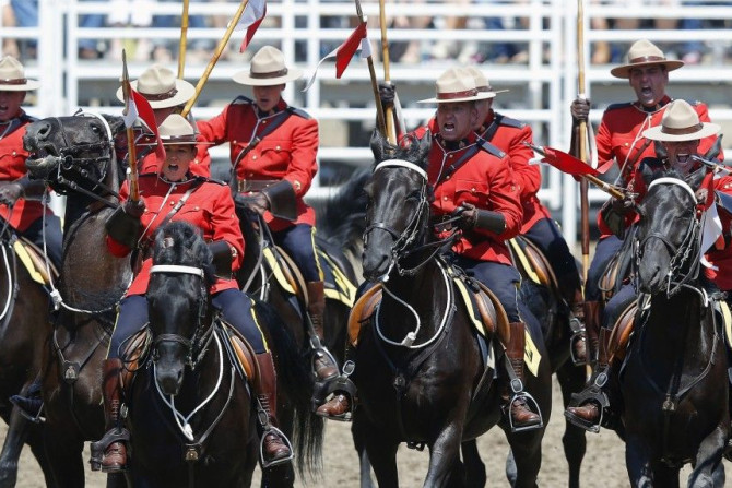 Members of the Royal Canadian Mounted Police (RCMP) Musical Ride demonstrate their charge