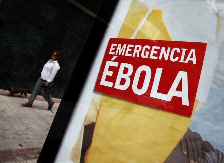 An advertisement for donations to fight Ebola in Africa is displayed on a bus stop near the apartment building 